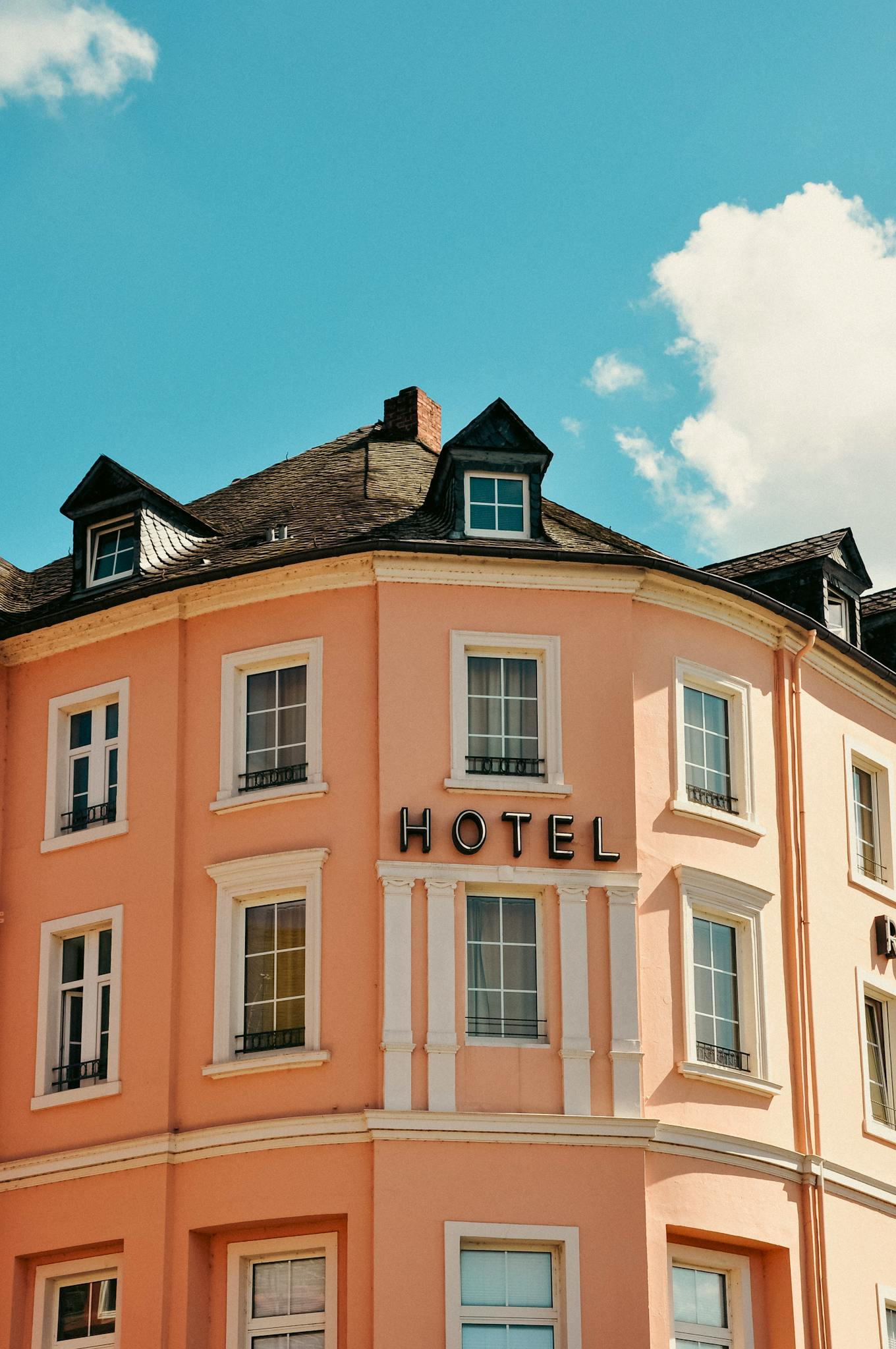Charming facade of a boutique hotel in Bernkastel-Kues under a clear summer sky.
