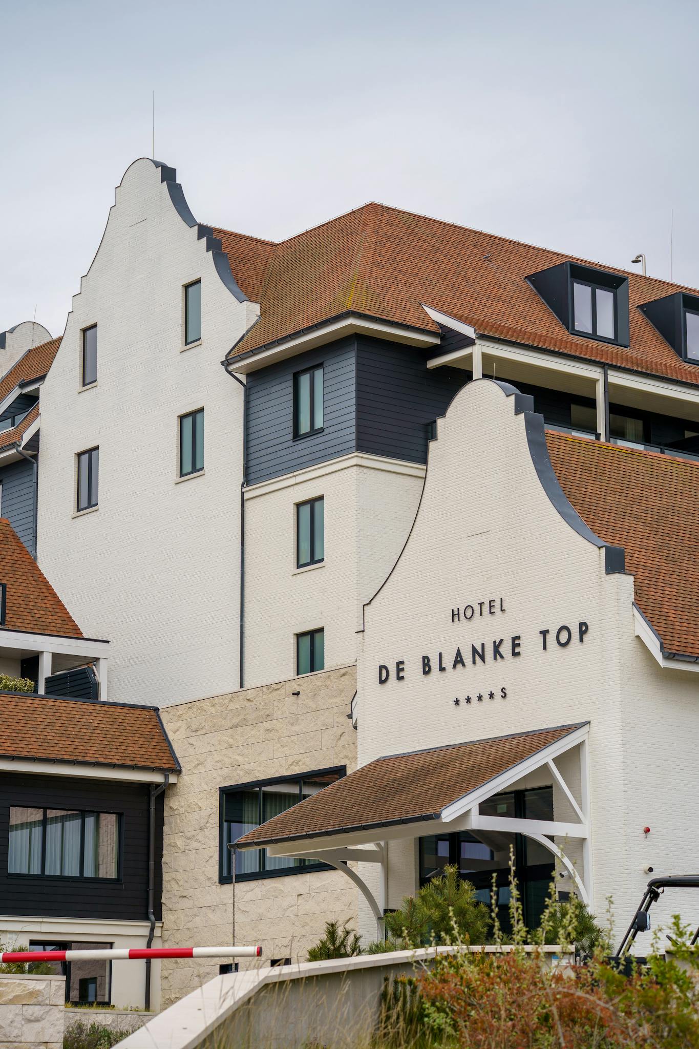 Elegant hotel facade in Cadzand, Zeeland showcasing classic Dutch architectural style with unique gable shapes.