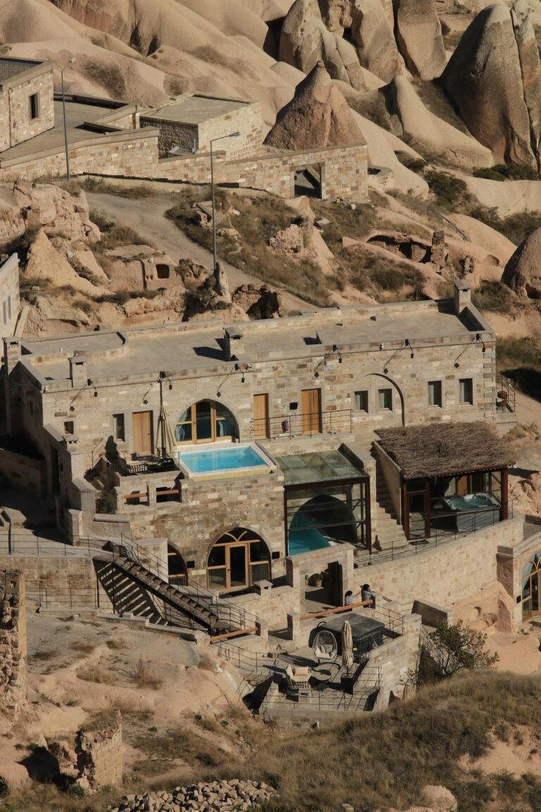 Stunning aerial view of a cave hotel set among the iconic rock formations in Cappadocia, Turkey.