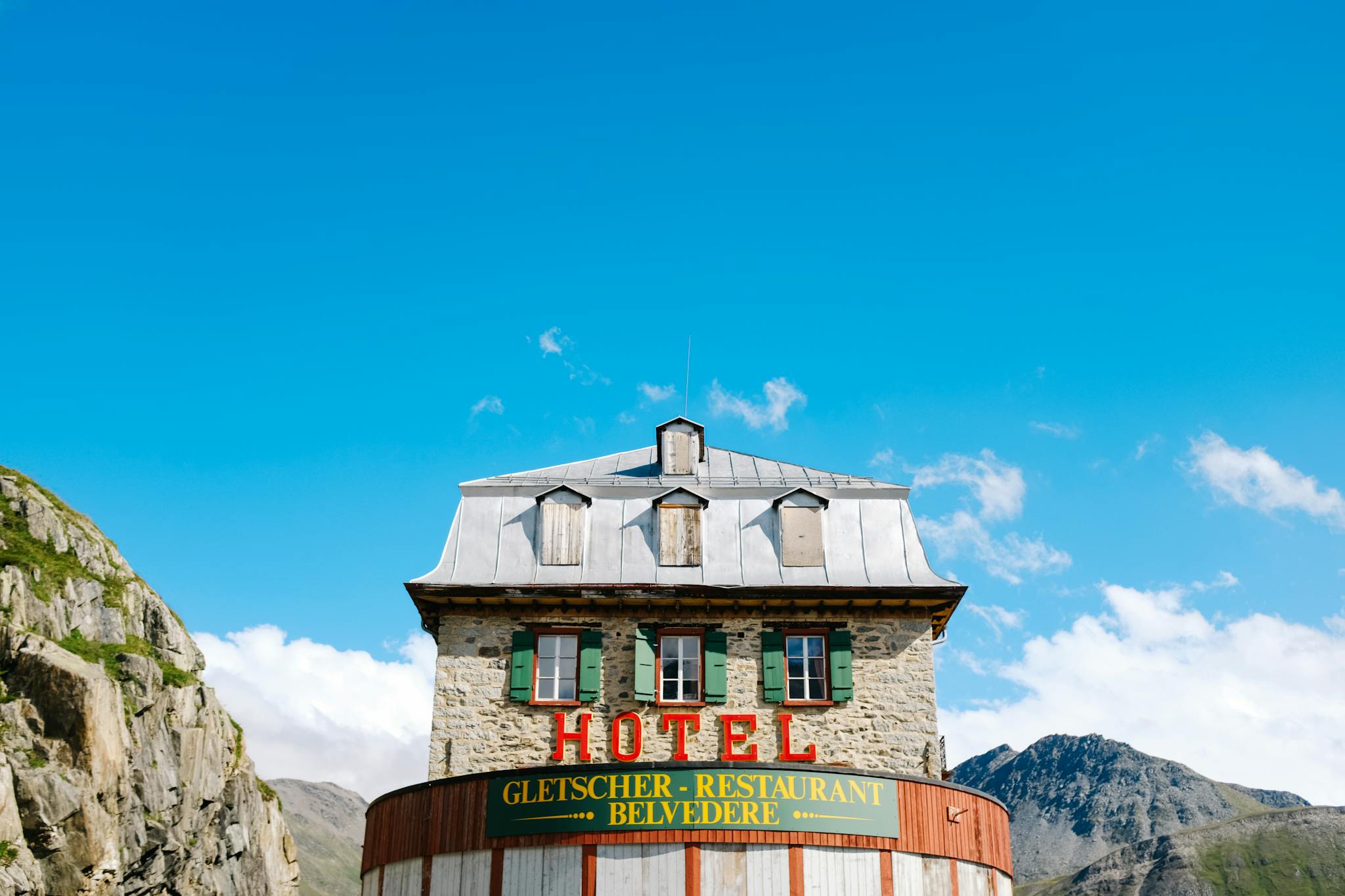 Stunning facade of the Belvedere Hotel in the Swiss Alps under a clear blue sky.